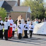 Catholic school mission to form leaders during Eucharist procession.