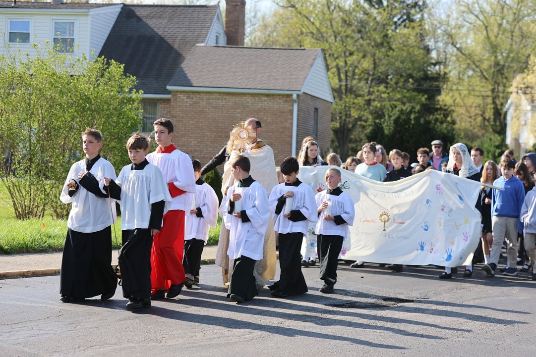 Catholic school mission to form leaders during Eucharist procession.