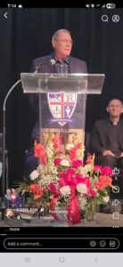 Grandfather speaking to Royalmont Academy graduate during graduation ceremony