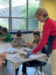 Royalmont teacher providing individualized support to elementary students.
