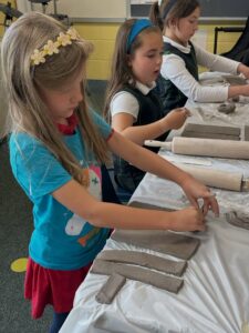 Royalmont Academy elementary students engaged in a hands-on clay project