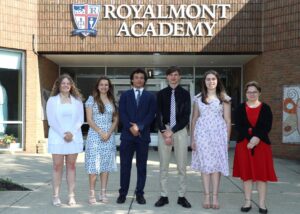 Royalmont Academy graduates standing together outside the school